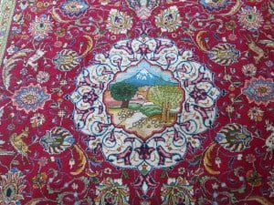a dark red rug with Oriental patterns