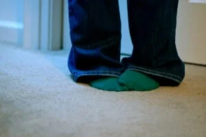 pets-and-sofa-300×225 legs with socks on a white carpet