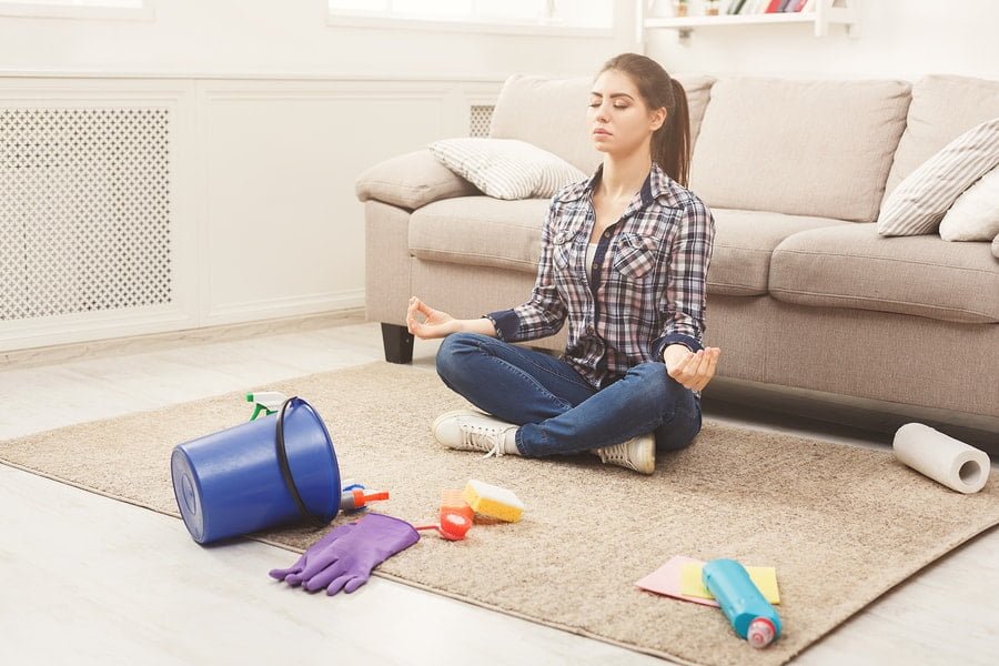 person meditating on clean rug