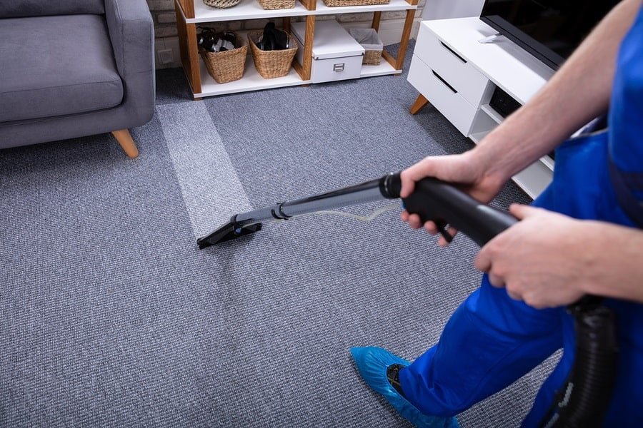 technician cleaning a fitted carpet